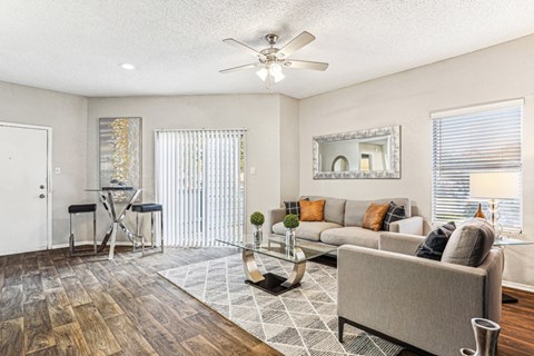 Bright and airy living room with large windows at Laurels of Sendera apartments in Arlington, TX